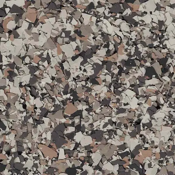 The image shows a textured surface with a pattern of variously sized, multicolored fragments in shades of gray, brown, and beige.