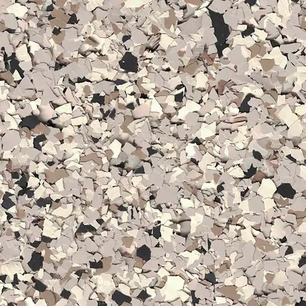 A scattered pattern of beige, cream, black, and brown flakes, resembling a speckled or terrazzo surface with a textured appearance.