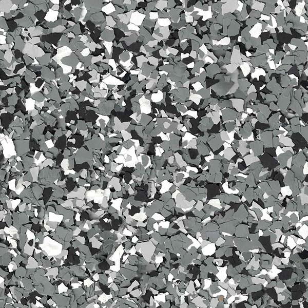 A textured surface with a mix of gray, black, and white chips creating a speckled, abstract pattern, like terrazzo flooring.